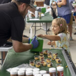 handing out bbq samples at the ohio eggfest, young girl voting for her favorite cook team