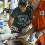 captain ron at the ohio eggfest seasoning steak with fogo charcoal rub