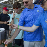 grabbing a slice of wood fired pizza at the ohio eggfest big green egg bbq competition